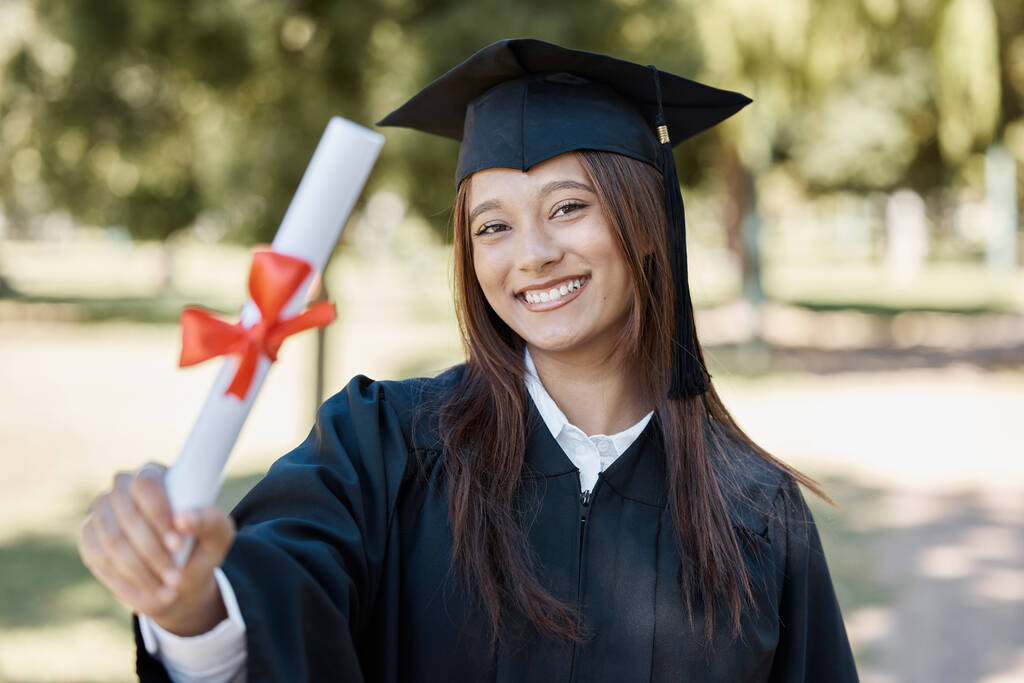 在大学、毕业典礼上获得毕业文凭的女生在校园微笑,以获得成功、奖励和成就感.拥有证书、学位和学术卷轴的教育、大学和快乐的女毕业生.